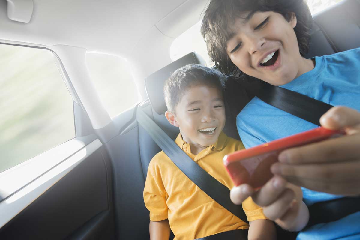 携帯ゲーム機を持つ2人の少年